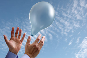 Releasing a balloon into the air concept for dreams and aspirati